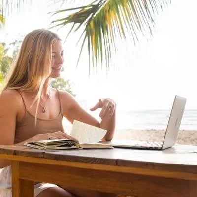 Spanish student sitting at her computer taking an online survival Spanish course