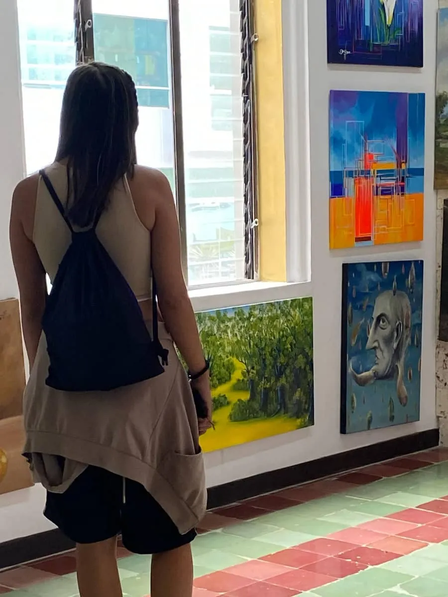 A female Toucan Spanish school student exploring the vibrant art scene in Colombia, an example of one of the Spanish immersion activities featured on the Toucan Spanish blog.